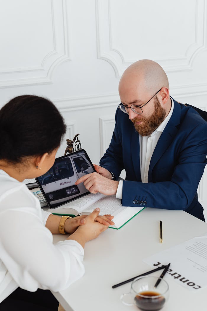 The Art of Drawing Readers In: Your attractive post title goes here Two professionals discussing a project using a digital tablet in a modern office.